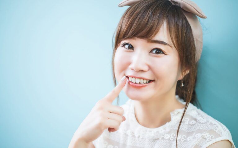 Asian Woman Pointing At Smile