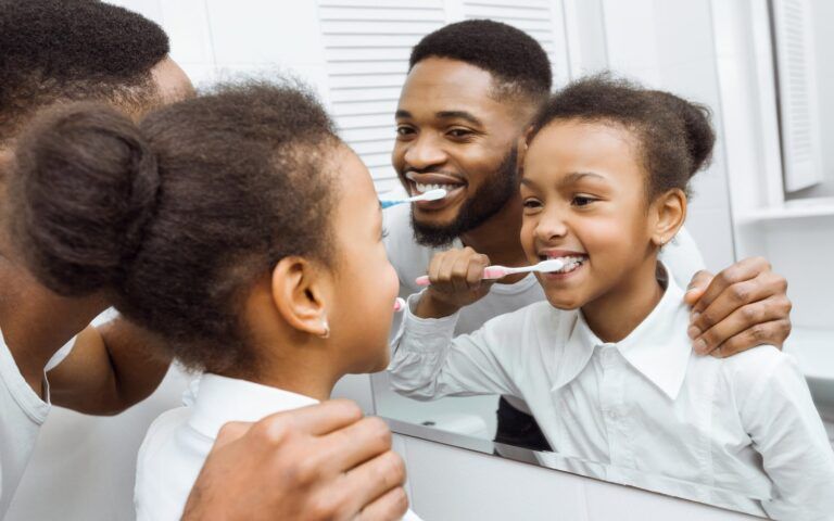 Family Brushing Teeth Together