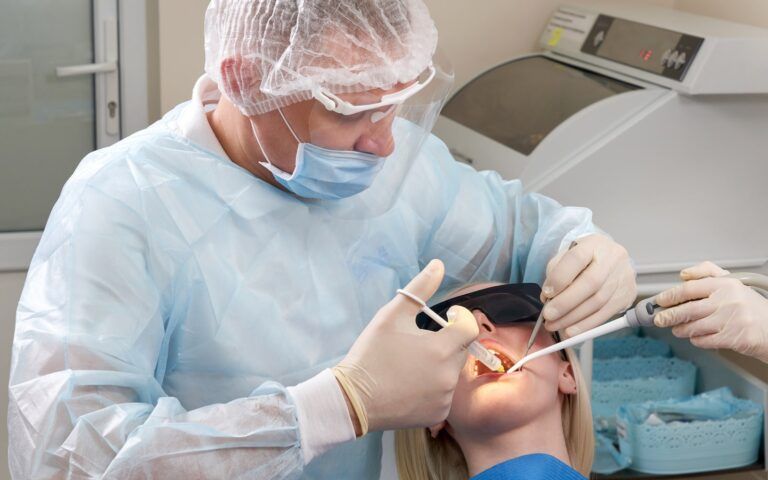 Dentist Performing Cosmetic Dental Procedure